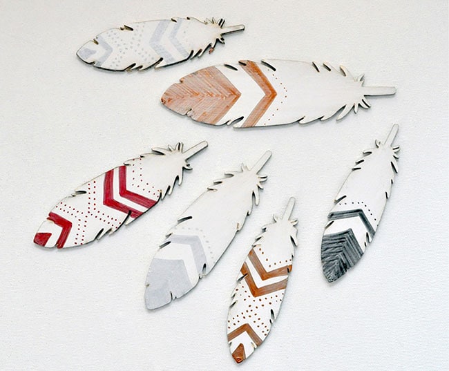 Decorate these white feathers with markers, paints, glitter and